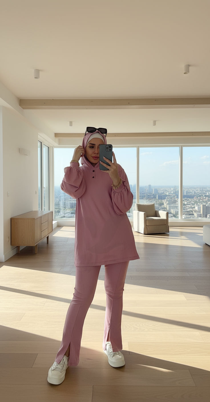 Person wearing a pink outfit taking a mirror selfie.